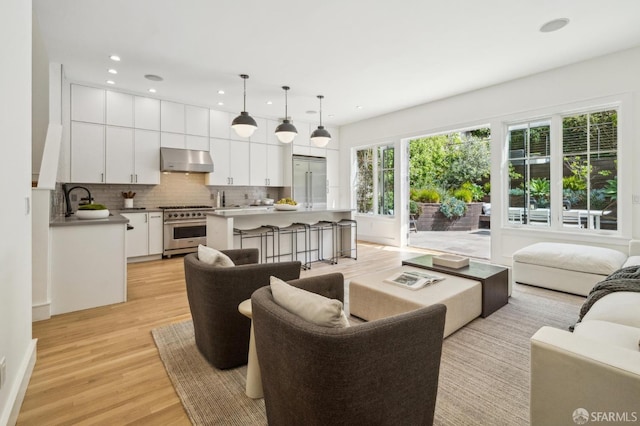 living room with recessed lighting and light wood finished floors