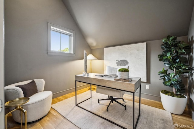 office featuring baseboards, wood finished floors, and lofted ceiling