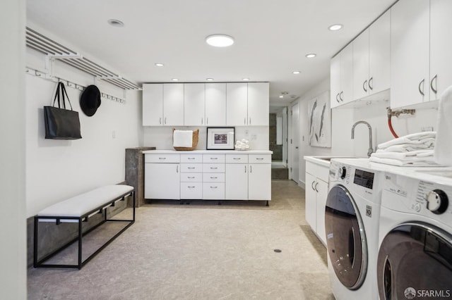 clothes washing area featuring recessed lighting, a sink, cabinet space, and washing machine and dryer