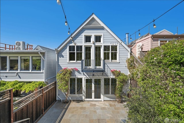 back of property with a patio area, fence, and french doors
