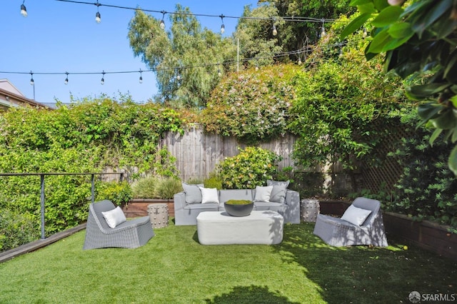 view of yard with an outdoor living space and a fenced backyard