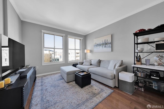 living room featuring ornamental molding, wood finished floors, and baseboards