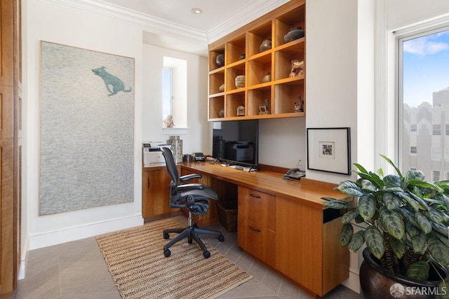 office space featuring built in desk, ornamental molding, and light tile patterned flooring