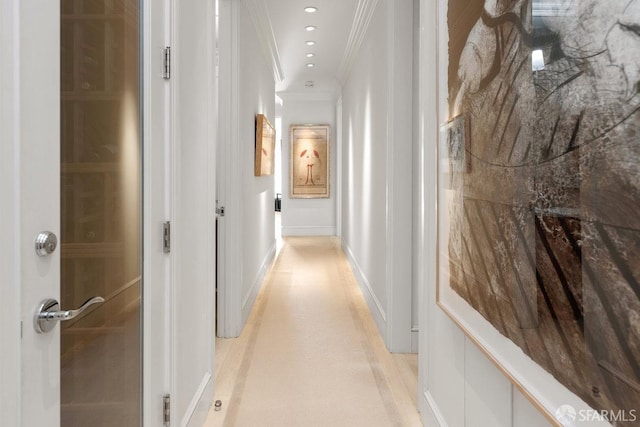corridor featuring ornamental molding and baseboards