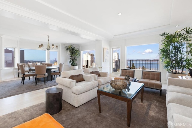 living area featuring a tray ceiling, recessed lighting, a chandelier, and wood finished floors