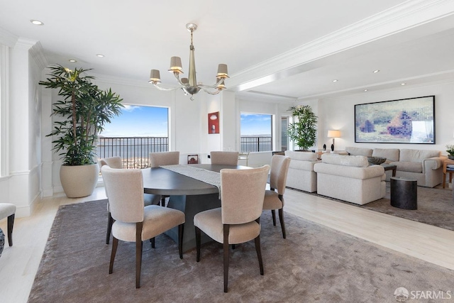 dining space with hardwood / wood-style flooring, crown molding, and a wealth of natural light