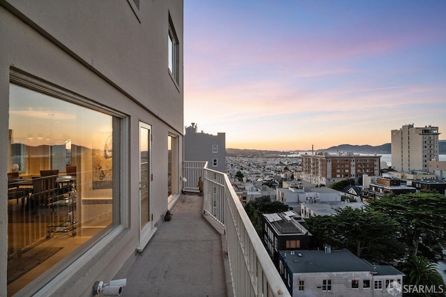 balcony with a mountain view and a view of city