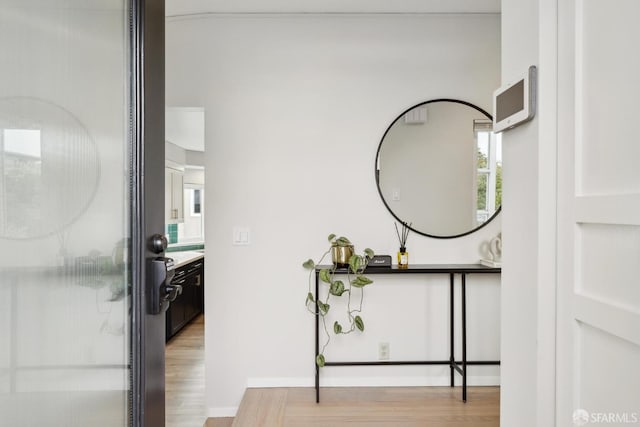 interior space with baseboards and wood finished floors