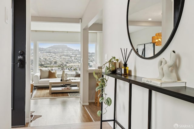 interior space with a city view, recessed lighting, and wood finished floors