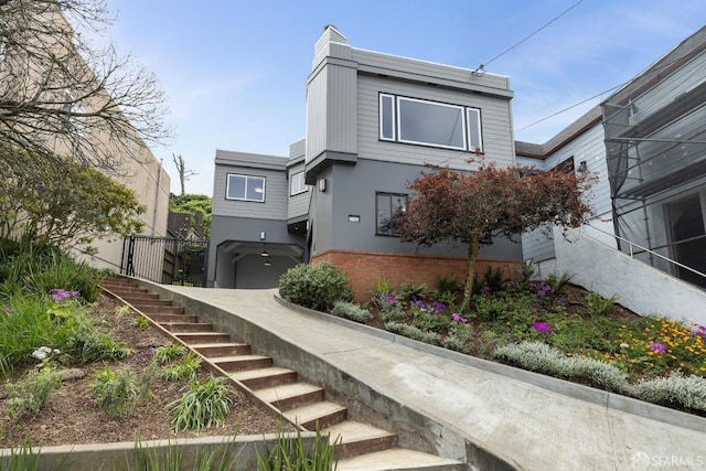 exterior space with stairs, stucco siding, and brick siding