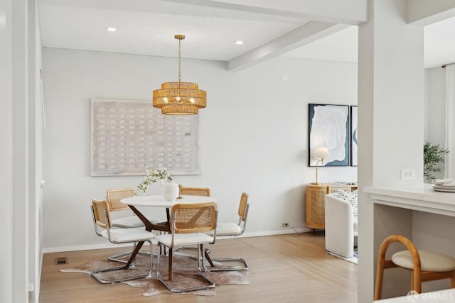 dining area with beamed ceiling, baseboards, an inviting chandelier, and wood finished floors