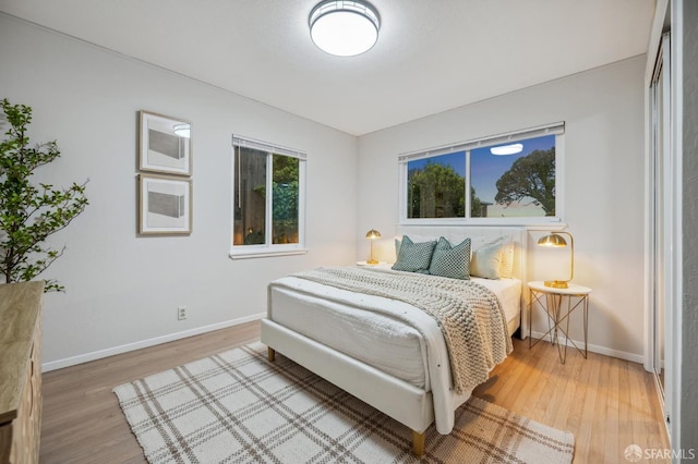 bedroom featuring baseboards and light wood-style floors
