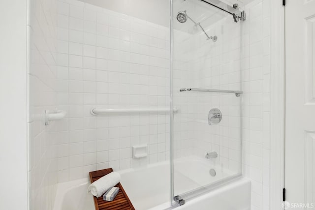 bathroom with shower / bath combination with glass door