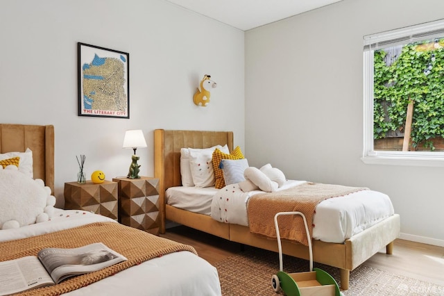 bedroom featuring baseboards and wood finished floors