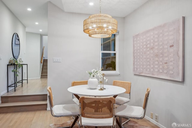 dining area with stairs, wood finished floors, baseboards, a notable chandelier, and recessed lighting