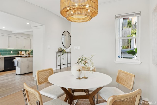 dining area featuring recessed lighting, a notable chandelier, and light wood finished floors