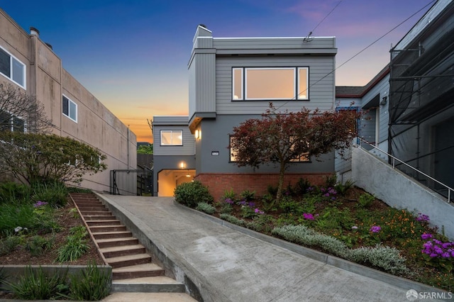 contemporary home with stairs and stucco siding