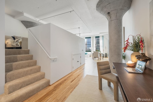 interior space with floor to ceiling windows and wood-type flooring