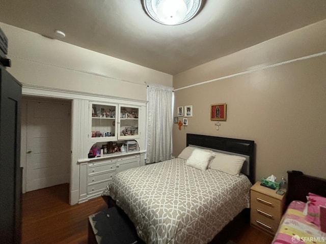 bedroom with dark wood finished floors