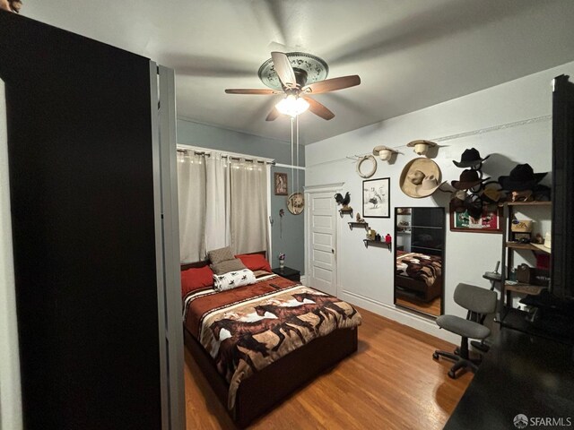 bedroom with wood finished floors and ceiling fan