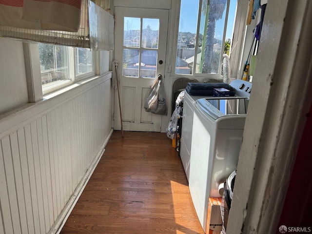 laundry area featuring independent washer and dryer, wood finished floors, and laundry area