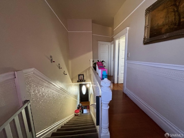 stairs with baseboards and wood finished floors