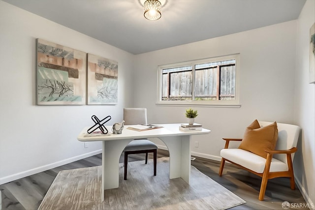 office area with dark wood-style flooring and baseboards