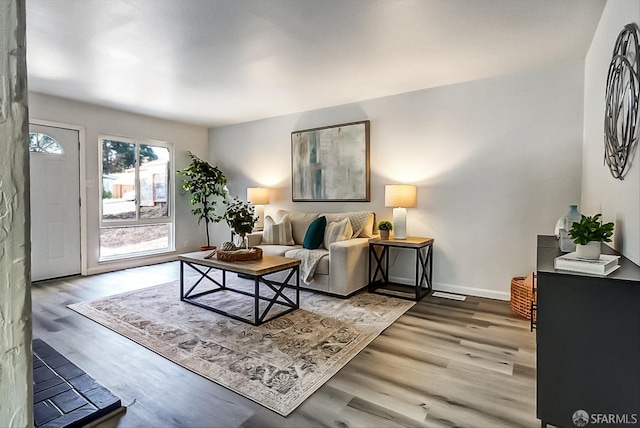 living area with wood finished floors and baseboards