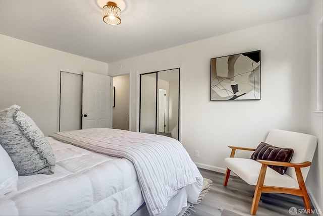 bedroom with wood finished floors and baseboards