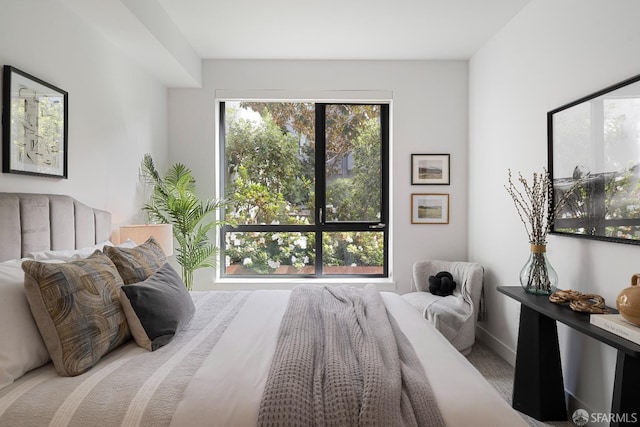 bedroom with multiple windows and baseboards