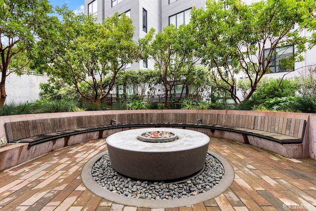 wooden terrace with a patio area and a fire pit