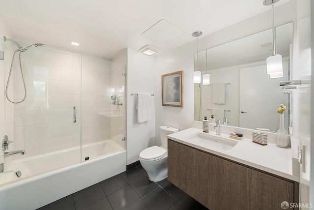 bathroom featuring vanity, visible vents, bath / shower combo with glass door, tile patterned flooring, and toilet