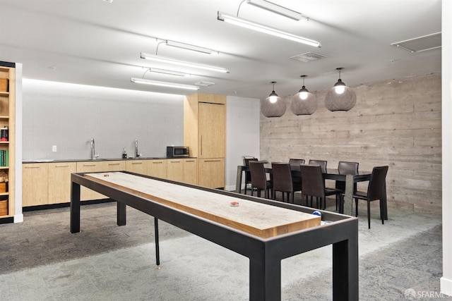 game room featuring carpet flooring, visible vents, and a sink