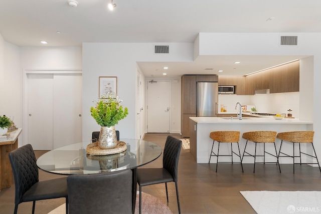 dining room featuring recessed lighting, wood finished floors, and visible vents