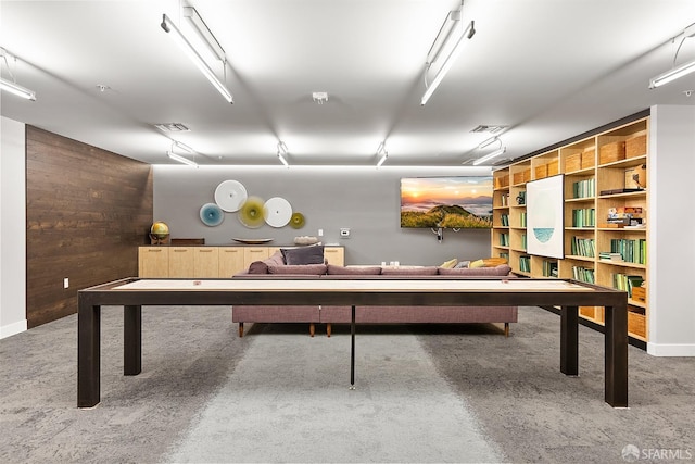 recreation room featuring visible vents and wood walls