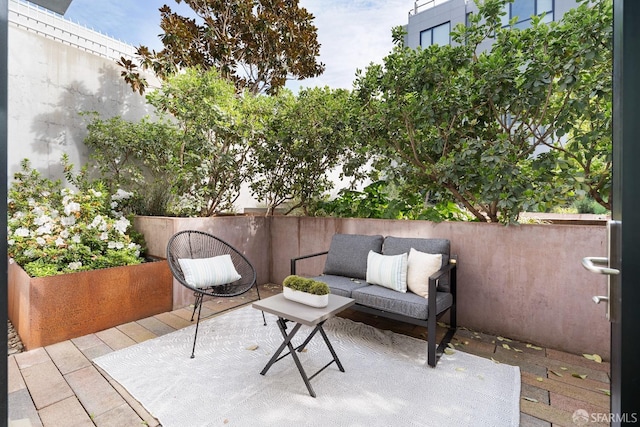 view of patio / terrace featuring outdoor lounge area and fence