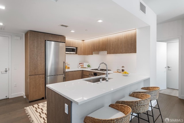 kitchen featuring light countertops, visible vents, appliances with stainless steel finishes, and a sink