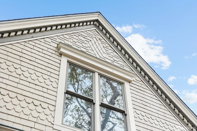 view of home's exterior with a shingled roof