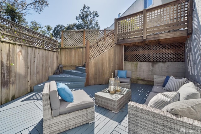 wooden terrace with an outdoor living space and a fenced backyard