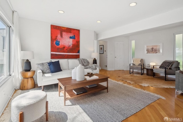 living room featuring recessed lighting, baseboards, and wood finished floors