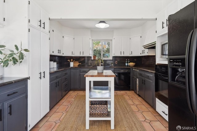 kitchen with white cabinetry, black appliances, and backsplash