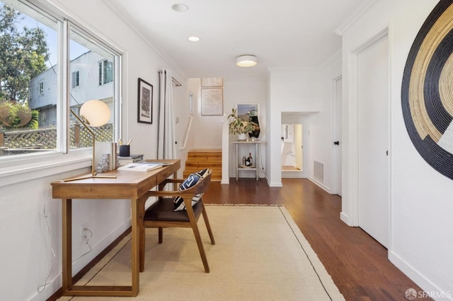 office space featuring visible vents, crown molding, baseboards, and wood finished floors