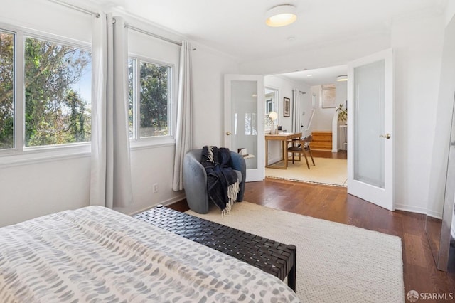 bedroom with baseboards and wood finished floors