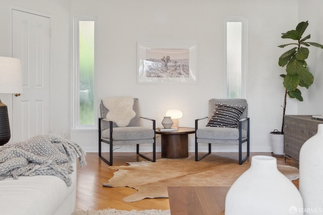 living area featuring baseboards and wood finished floors