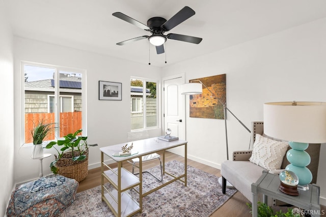 home office with ceiling fan, baseboards, and wood finished floors