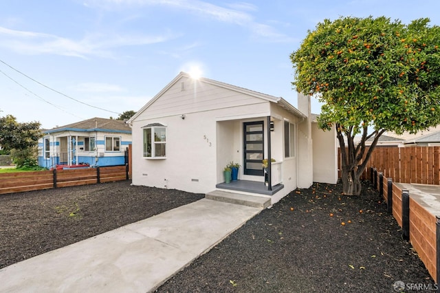 bungalow with crawl space, fence, and stucco siding