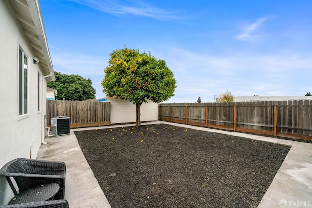 view of yard featuring a fenced backyard, a patio area, and cooling unit