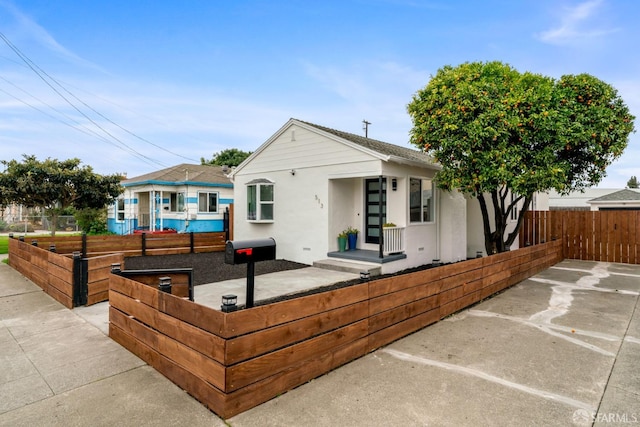 view of front of property featuring a fenced front yard and stucco siding