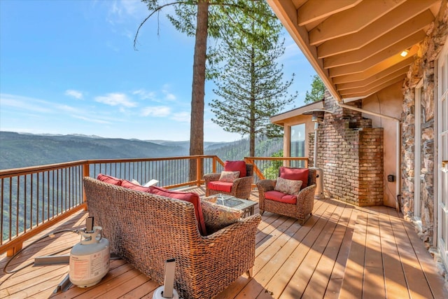 wooden deck featuring a mountain view and outdoor lounge area