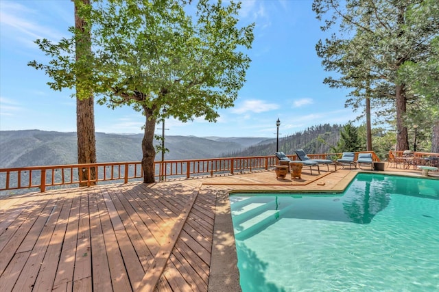 view of pool featuring a deck with mountain view